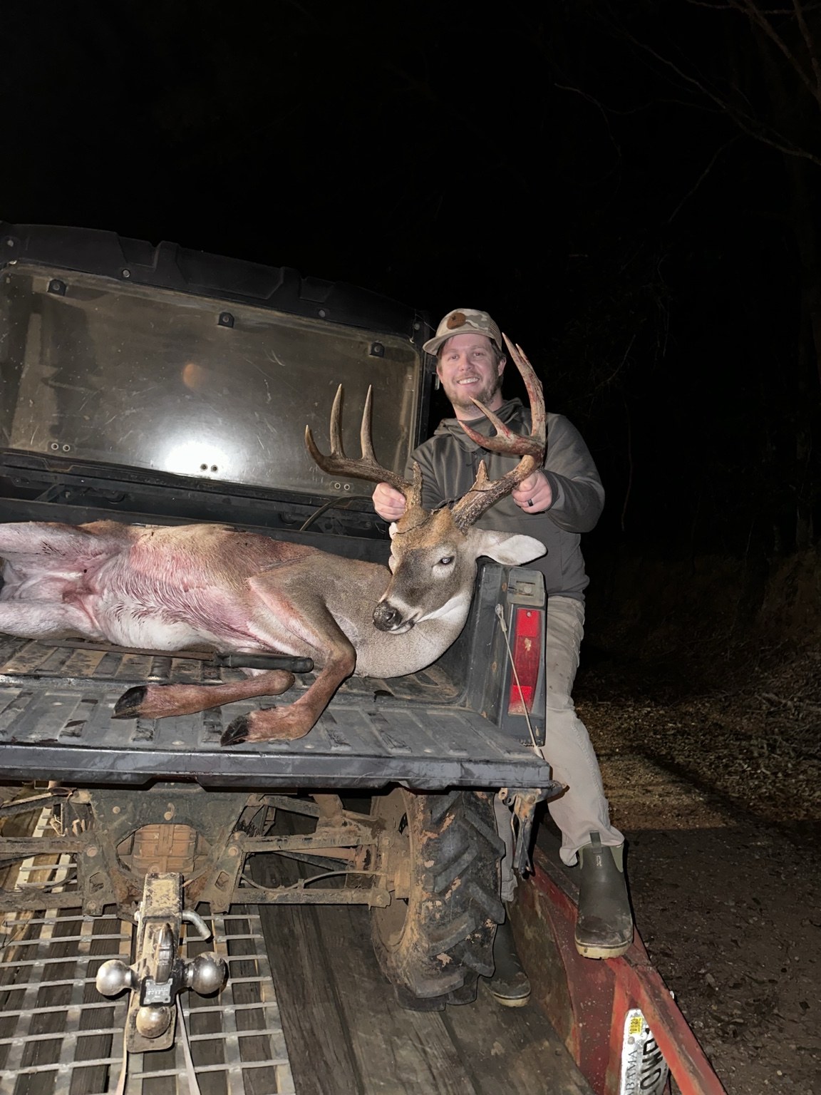 Customer with a harvested buck on a utility vehicle